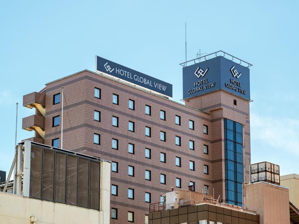 a building with a sign on top of it at Hotel Global View Nagaoka in Nagaoka