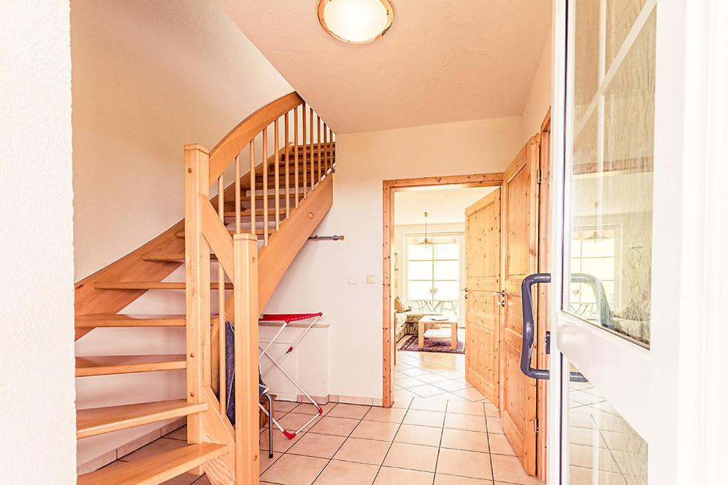 a wooden staircase in a house with a hallway at Wiesenglück in Abtsgmünd