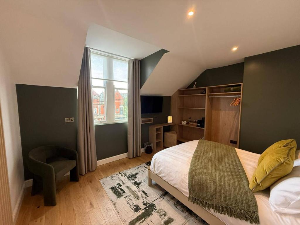 a bedroom with a large bed and a window at Auberge Hotel by Sasco in Lytham St Annes