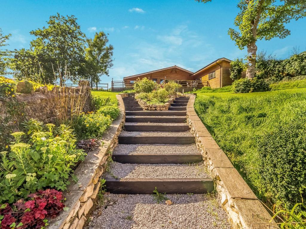 a set of stone stairs in a garden at Lovers Carriage - Uk46404 in Cowbridge