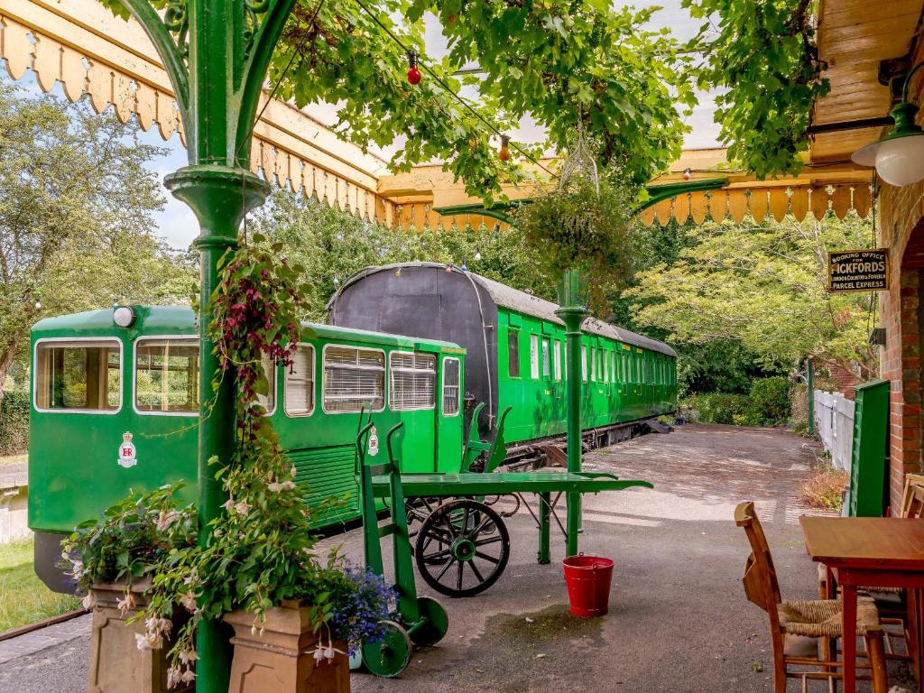 a green train sitting inside of a building at Sprat & Winkle in Horsebridge