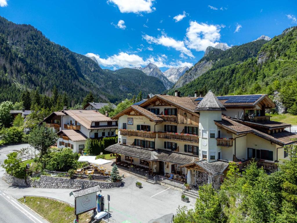 a view of a resort with mountains in the background at Pineta Pastry Hotel in Rocca Pietore