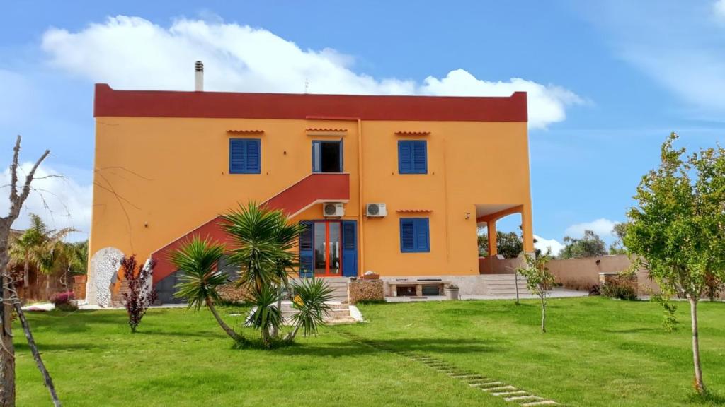 a large yellow house with a red roof at Charming House in Gallipoli + Terrace in Gallipoli
