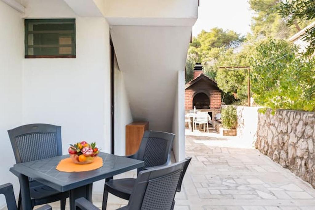 a table with a bowl of fruit on a patio at Charming Studio in Zavala - 25 m² - Parking Included in Zavala