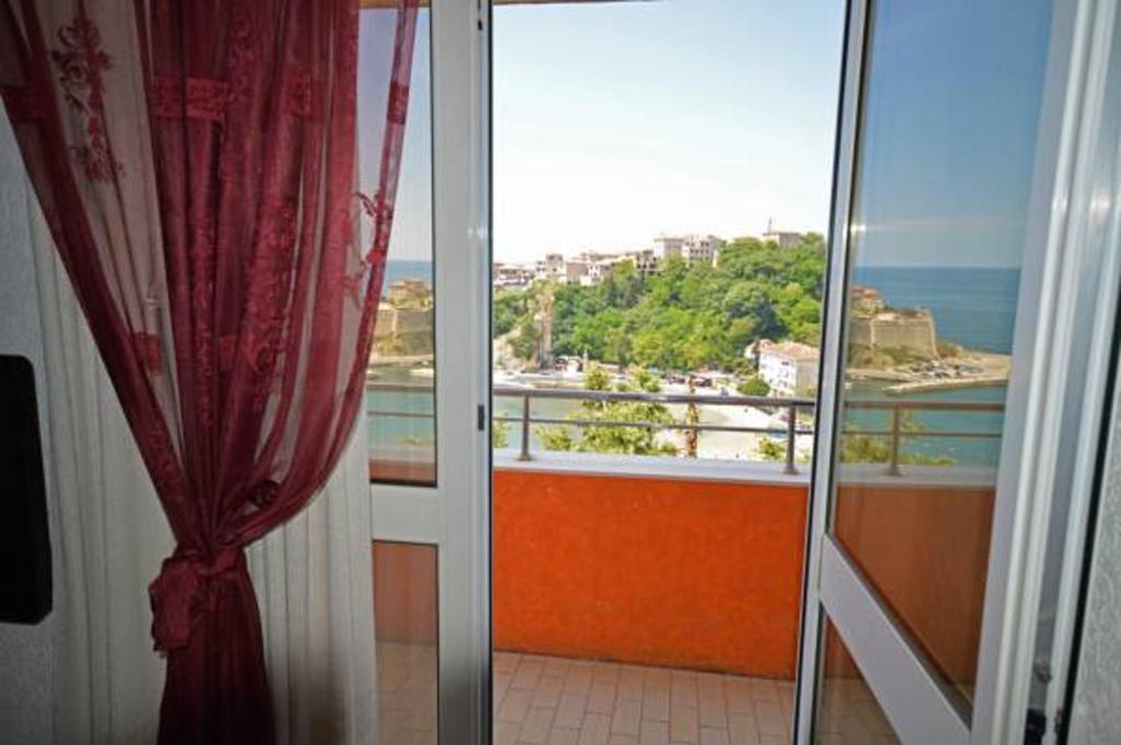 a room with a balcony with a view of the ocean at Sea View Apartment - Ulcinj - 40 sqm in Ulcinj