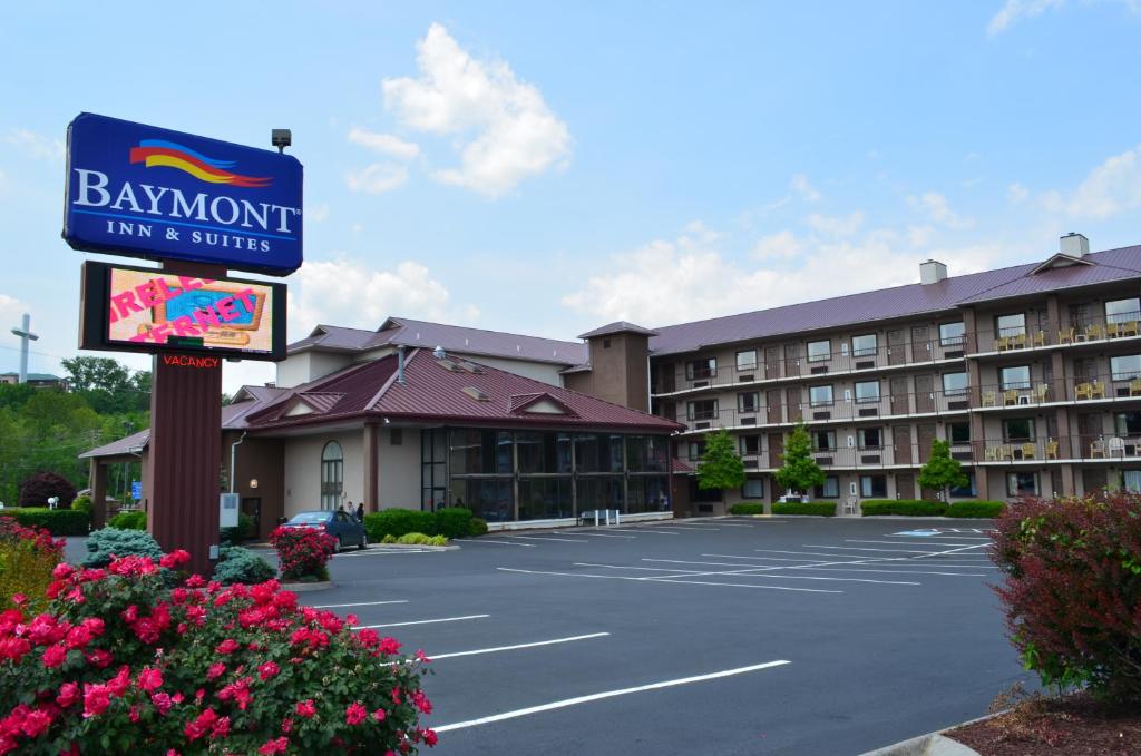 a sign in a parking lot in front of a hotel at Baymont by Wyndham Pigeon Forge near Island Drive in Pigeon Forge
