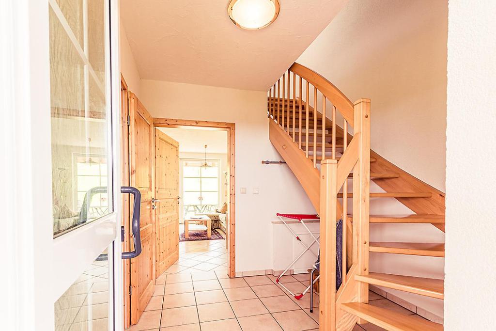 a hallway with a wooden staircase in a house at Waldlust in Abtsgmünd