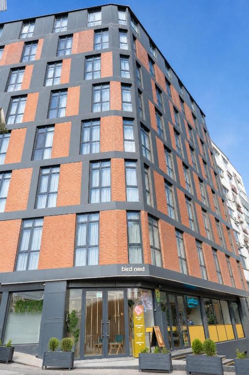 a tall brick building with windows on a street at Bird Nest Suites in Istanbul