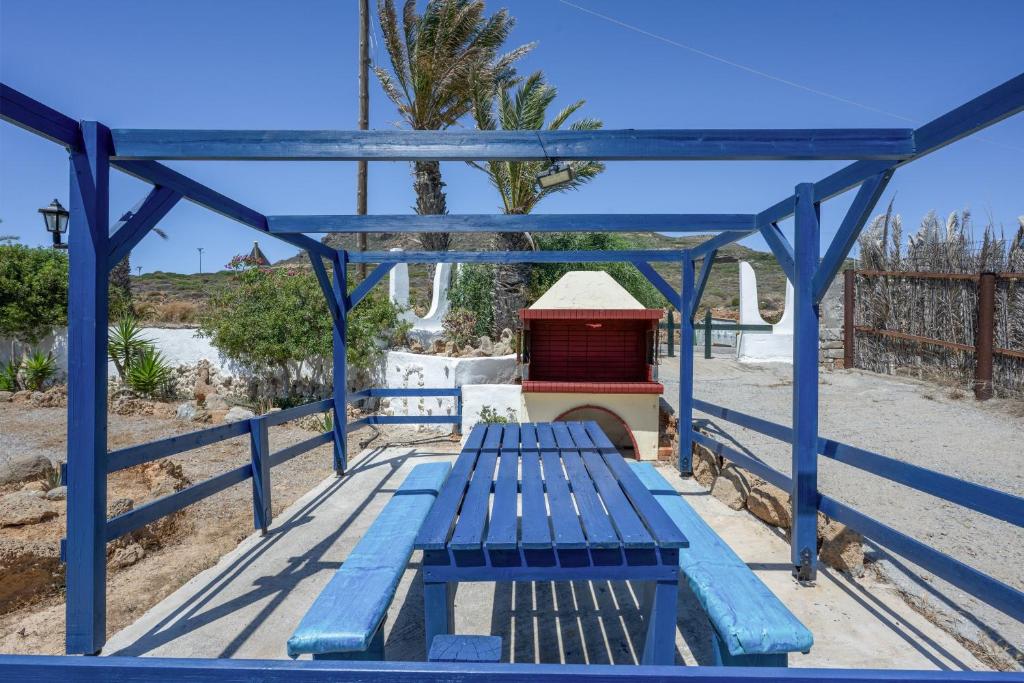 a blue bench sitting under a blue bridge at Elia Cottage in Sitia