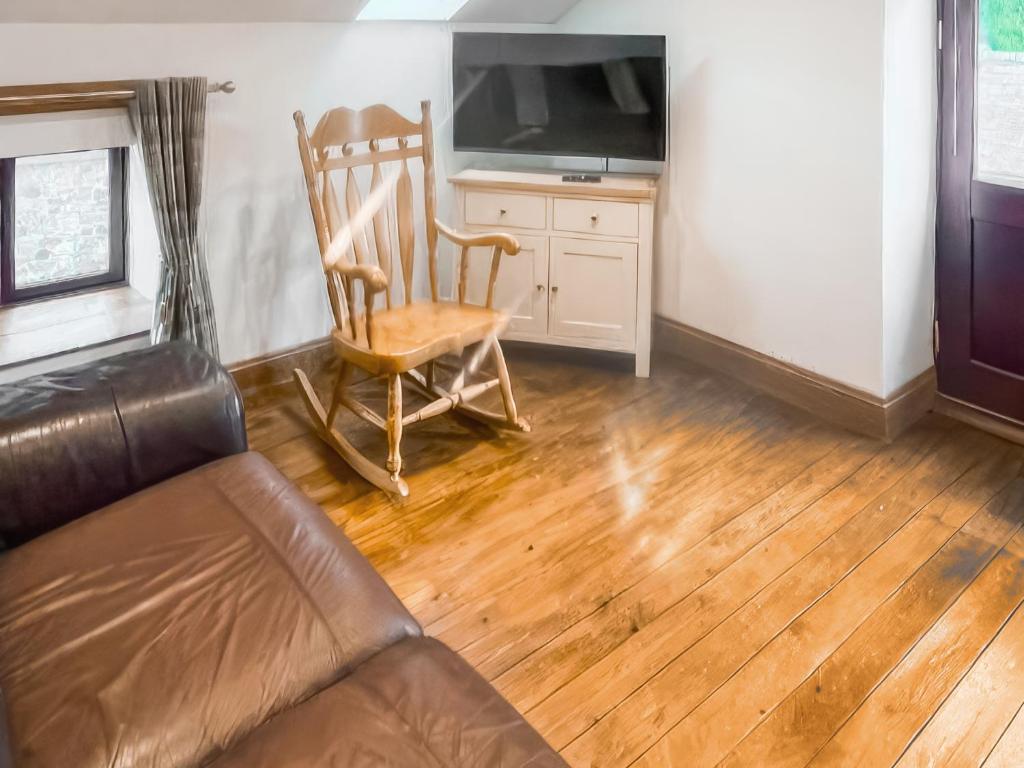 a living room with a couch and a chair and a television at Stewards Granary - Uk48306 in Berwick-Upon-Tweed