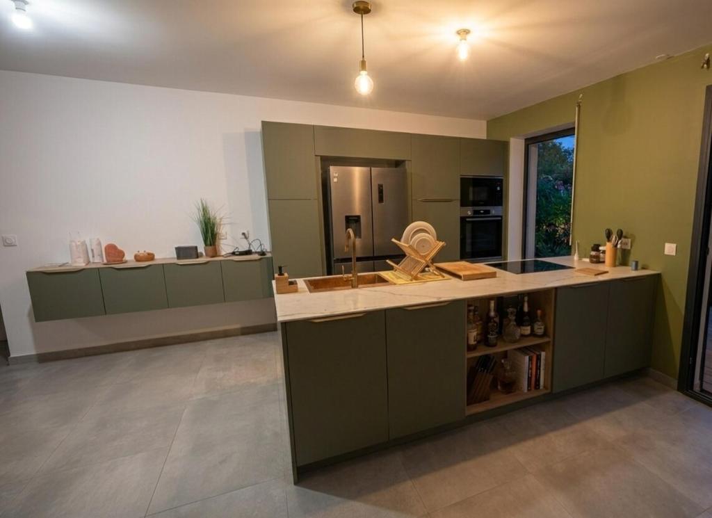 a kitchen with green cabinets and a counter top at Villa Aloa Private pool in Les Abymes