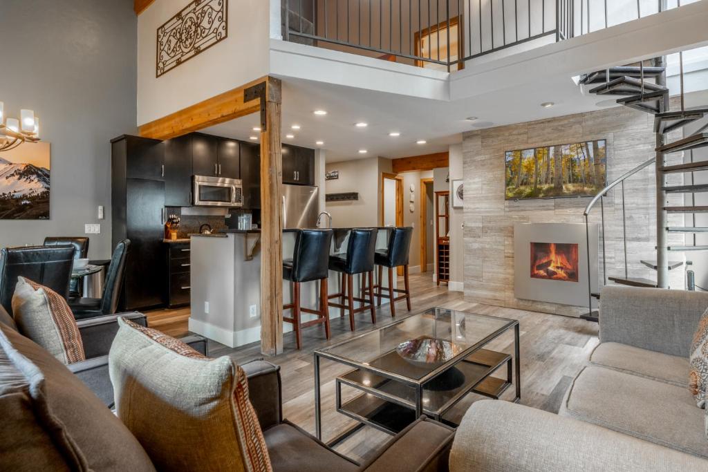 a living room with a fireplace and a table at Western Slope Villa 22 in Mammoth Lakes