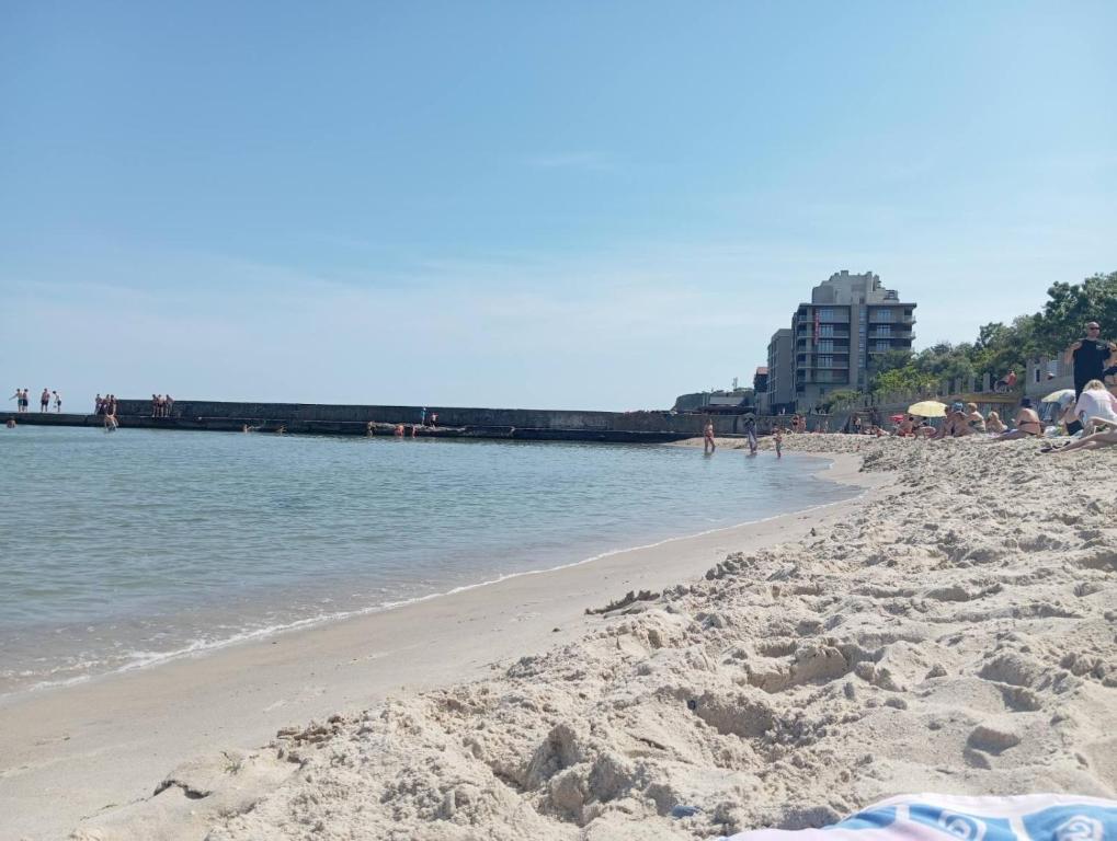 a beach with people on it and the water at Будинок у моря in Odesa