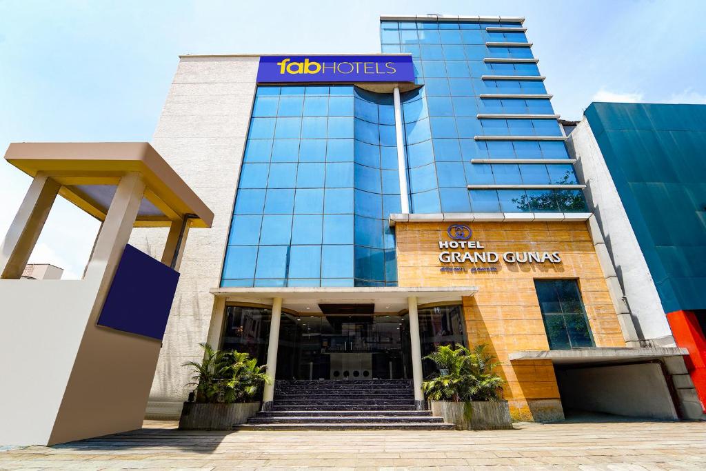 a building with a sign that reads job hotels at FabHotel Grand Gunas in Coimbatore