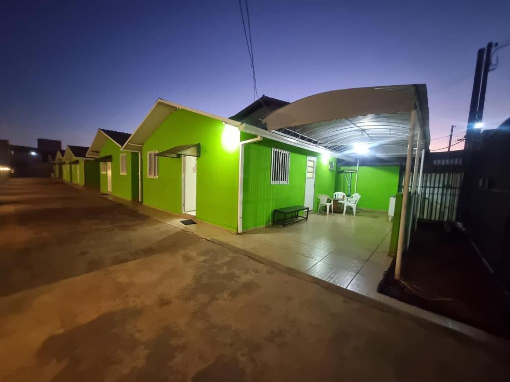 a green house in a parking lot at night at Condomínio Gold in Três Lagoas