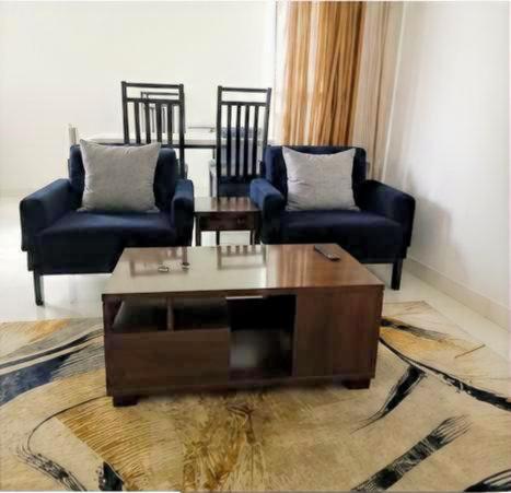 a living room with two chairs and a coffee table at Modern Family Home in Ikoyi in Lagos