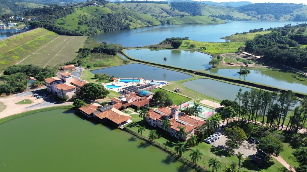 an aerial view of a house on a lake at Engenho da Serra Hotel EcoResort in Capitólio
