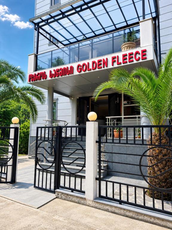 a building with a sign that reads marmite organism golden cheese at Golden Fleece Hotel in Ureki