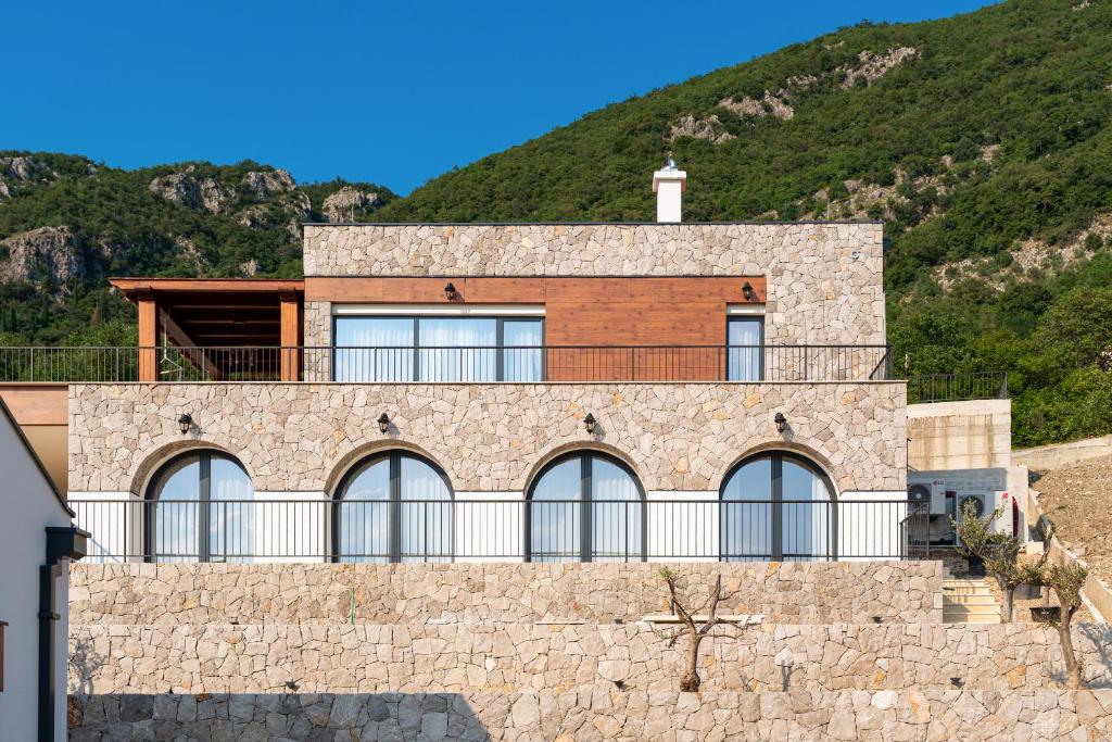 a house on top of a stone wall at Villa Verdura in Budva