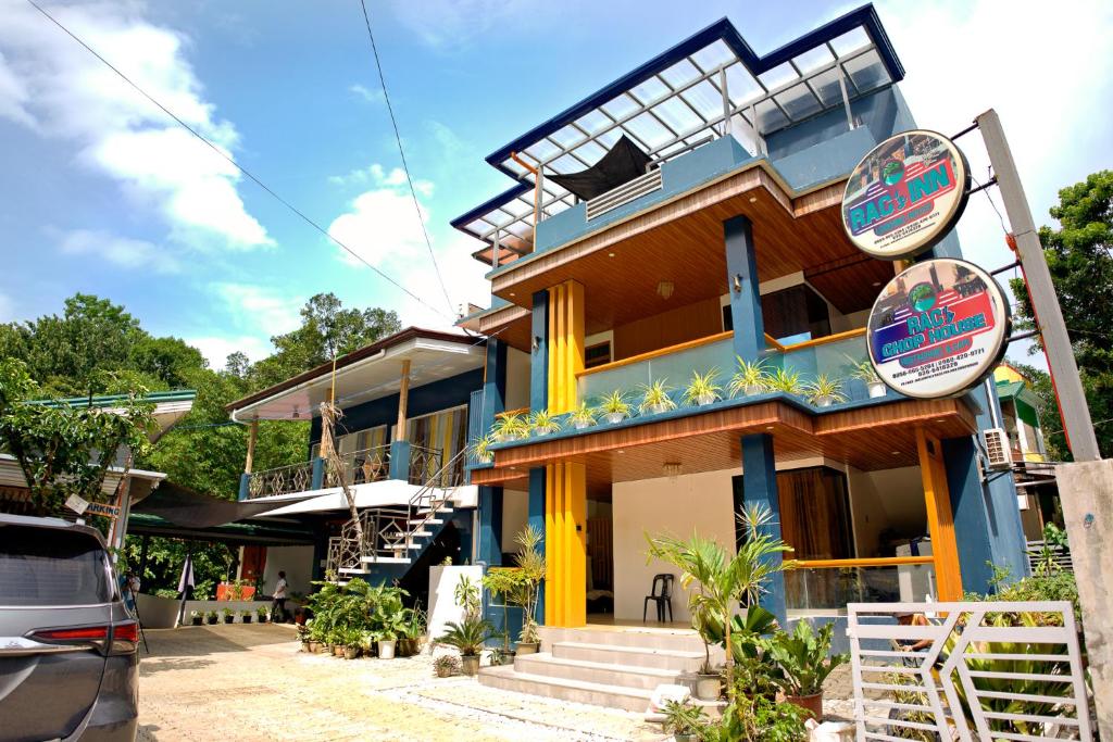 a house with a blue and yellow at RAC's Inn Malumpati in Pandan