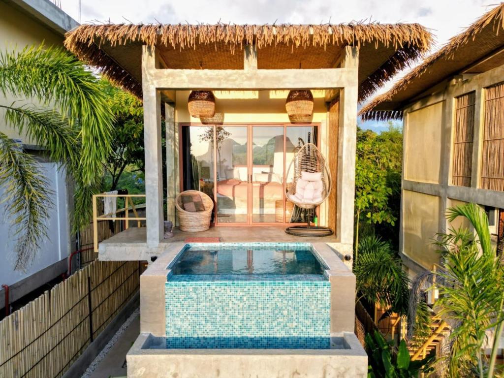 a house with a swimming pool in the backyard at VISTA Cadlao in El Nido Airport