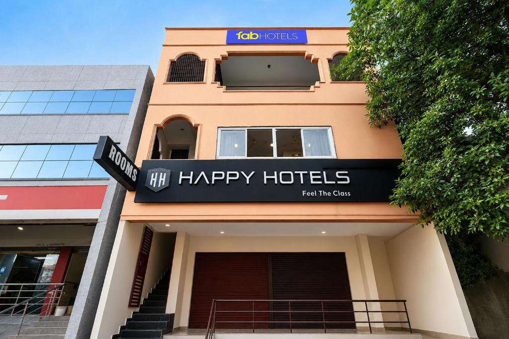 a building with a sign for a happy hotel at FabHotel Happy in Vijayawāda