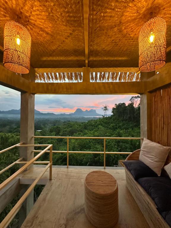 a living room with a view of the mountains at Vista Cadlao in El Nido