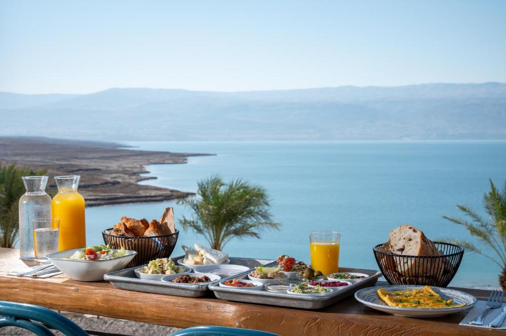 a table with plates of food on a table with a view at Glamping -420 in Kalia