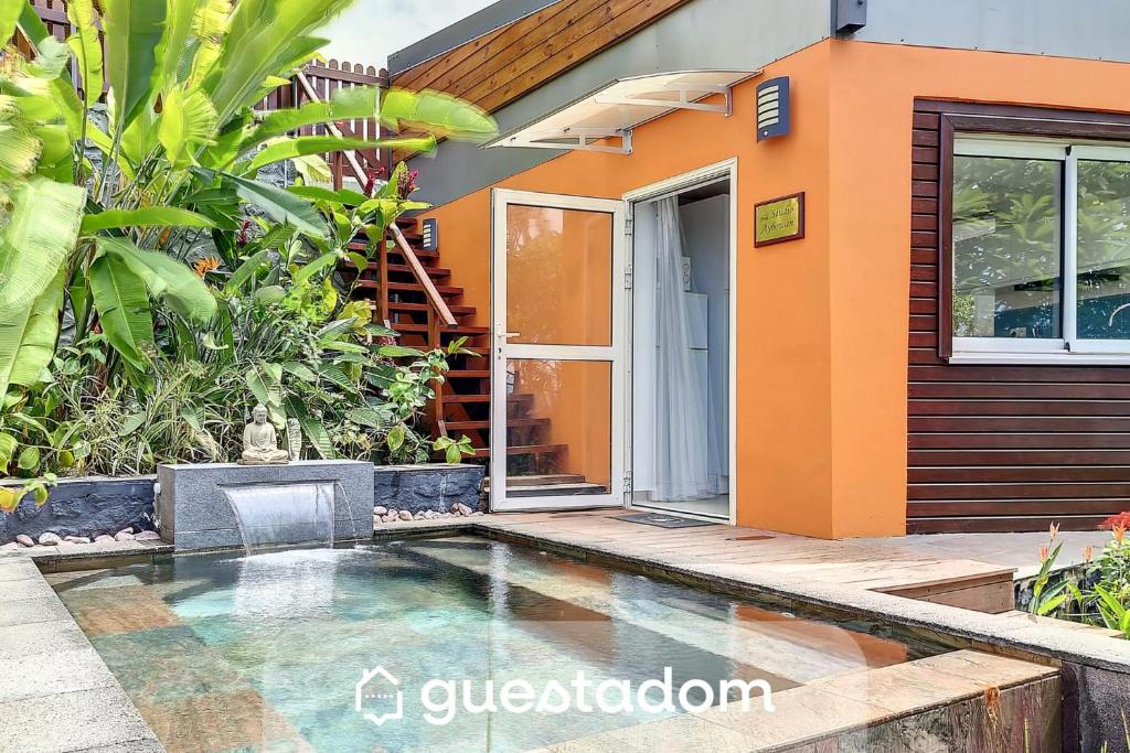 a house with a swimming pool in front of it at Aybowan - Jacuzzi - Climatisation in Les Avirons