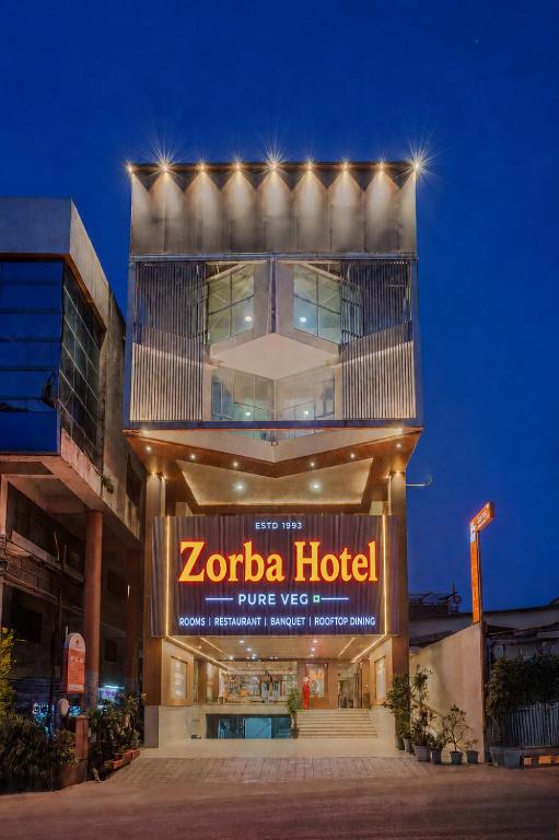 a zocalo hotel with a sign in front of it at Hotel Zorba Inn in Kolhapur