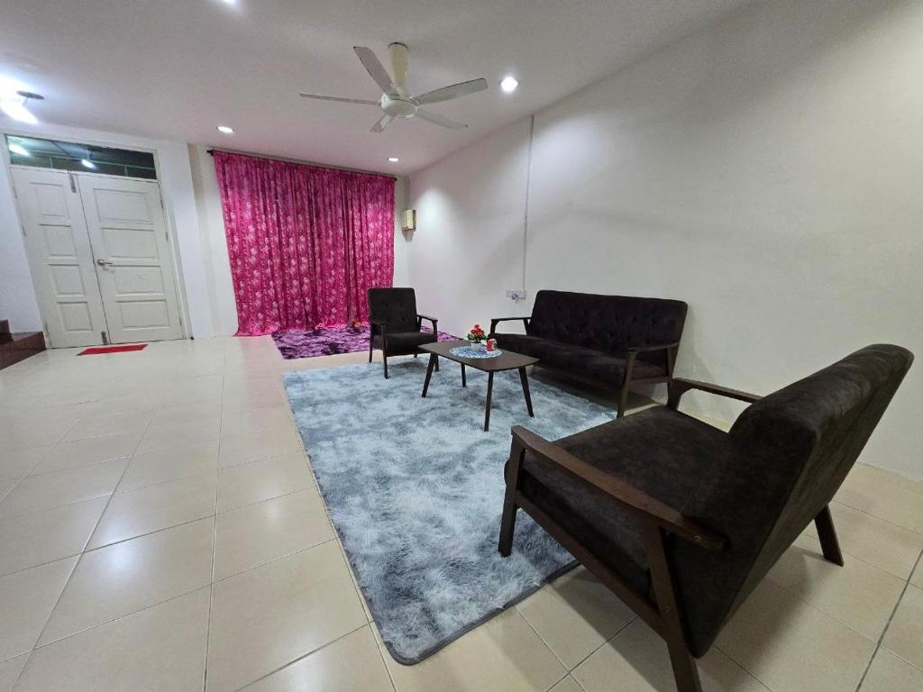 a living room with a couch and chairs and a table at AymanSyahir in Mukah