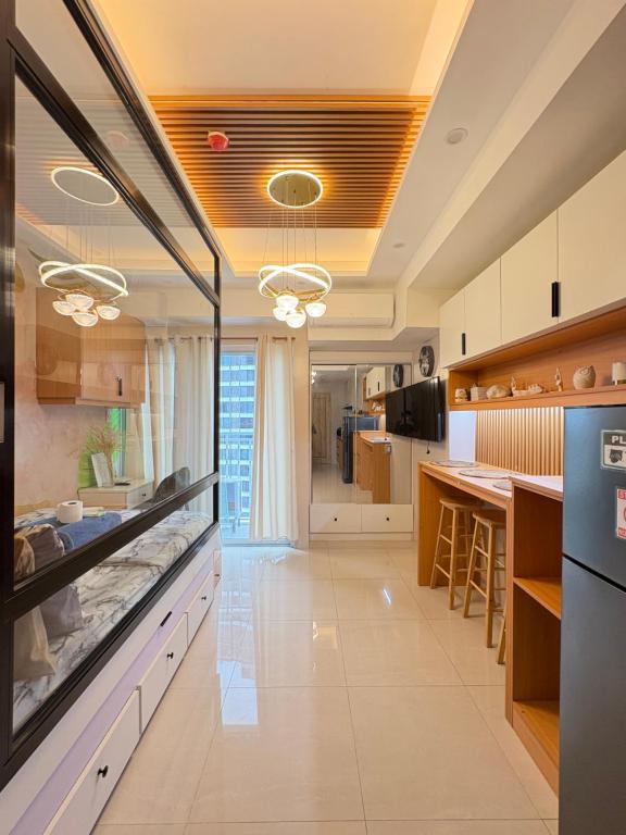 a large kitchen with a large aquarium in it at Inspiria Condominium in Davao City
