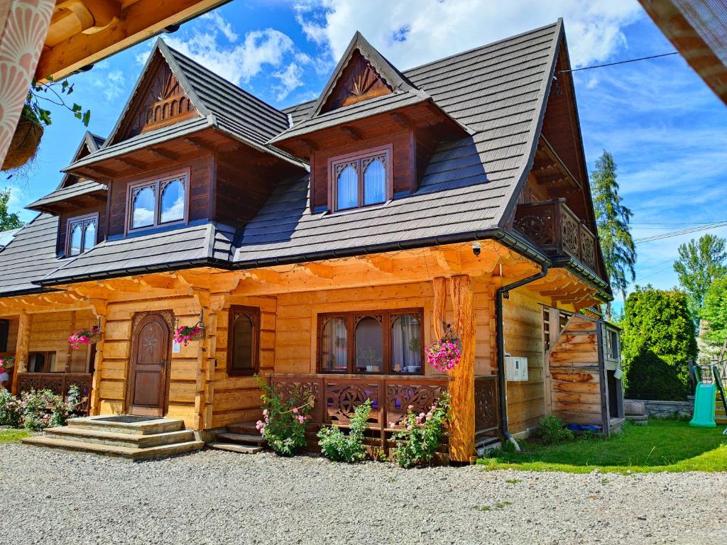 a wooden house with a gambrel roof at U Dziadka in Chochołów