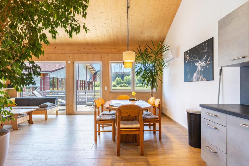 a kitchen and dining room with a table and chairs at Hubertus in Dietingen