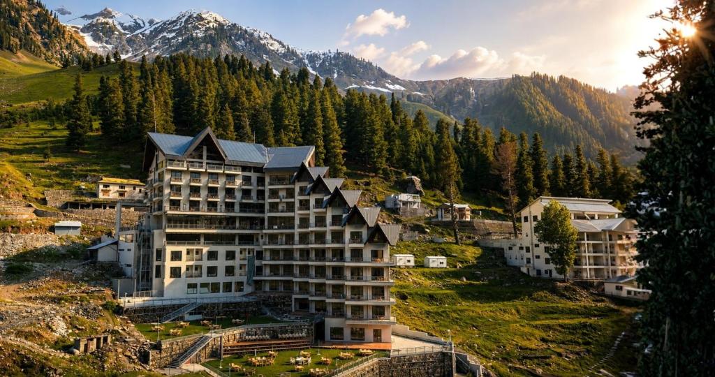 a hotel in the mountains with mountains in the background at Serene Resorts Naran in Naran