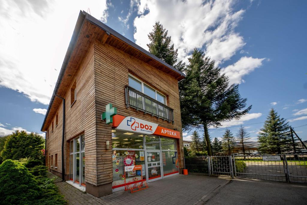a store with a sign on the front of it at Zawoja1560 Apartamenty przy Aptece in Zawoja