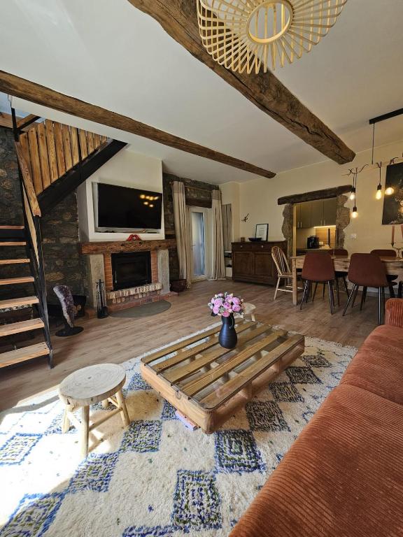 a living room with a couch and a fireplace at La Parenthèse Enchantée Chalet in Beuil