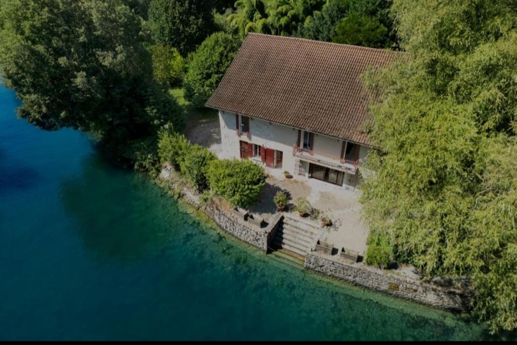 an aerial view of a house next to the water at La maison du lac in Vions