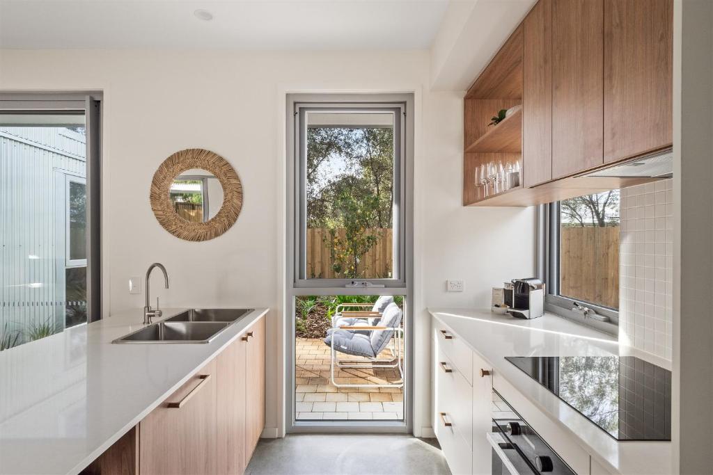 a kitchen with a sink and a large window at The Cape Collective 5 in Margaret River Town