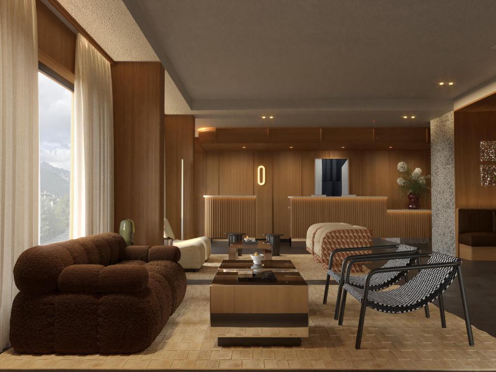 a living room with a couch and a table at Hotel Le Morgane in Chamonix