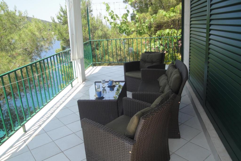 a patio with two chairs and a table on a balcony at Apartment Nono Ivo in Vis