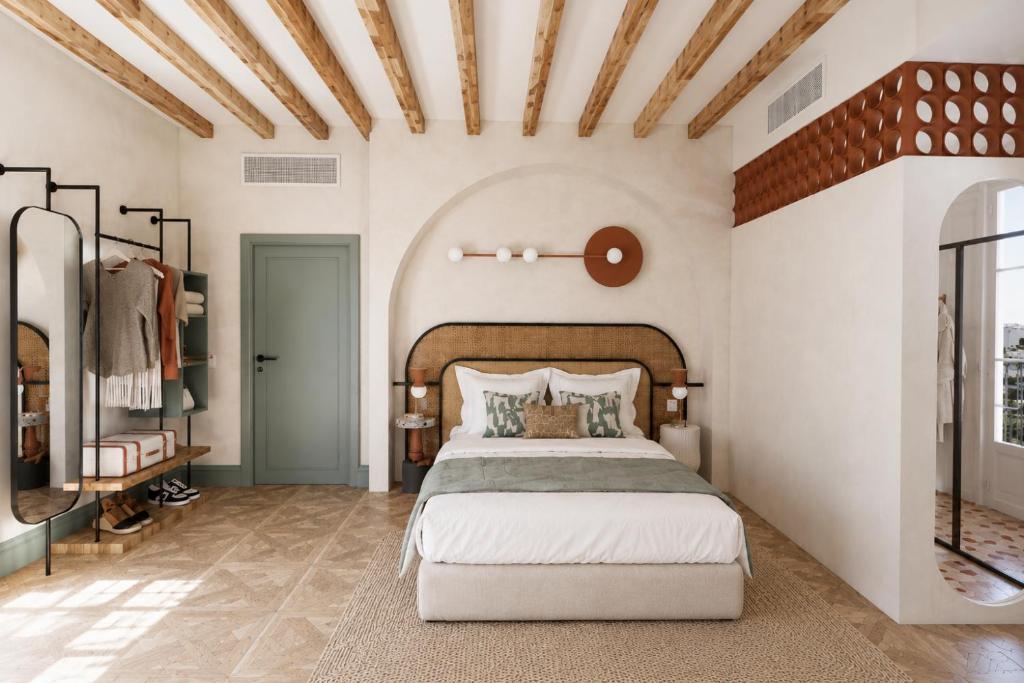 a bedroom with a large bed in a room at Hotel Casa Beatas in Málaga