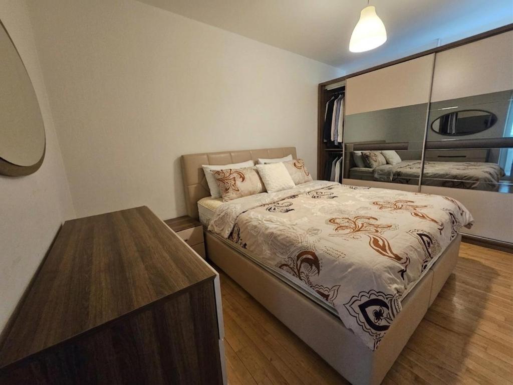 a small bedroom with a bed and a table at Nice 3 Rooms apartment in Copenhagen
