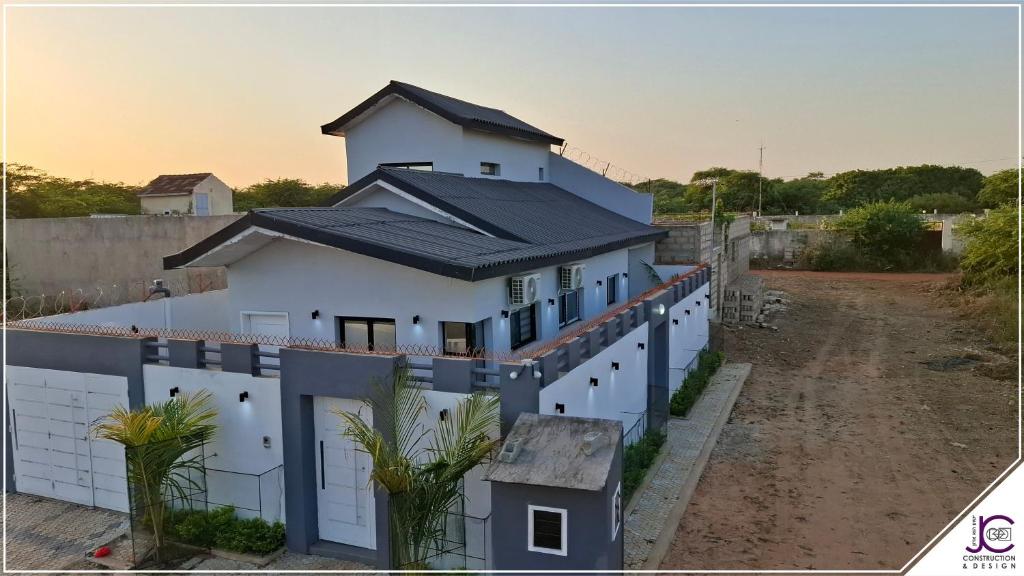a white house with a black roof at Villa La Lagune in Mbour
