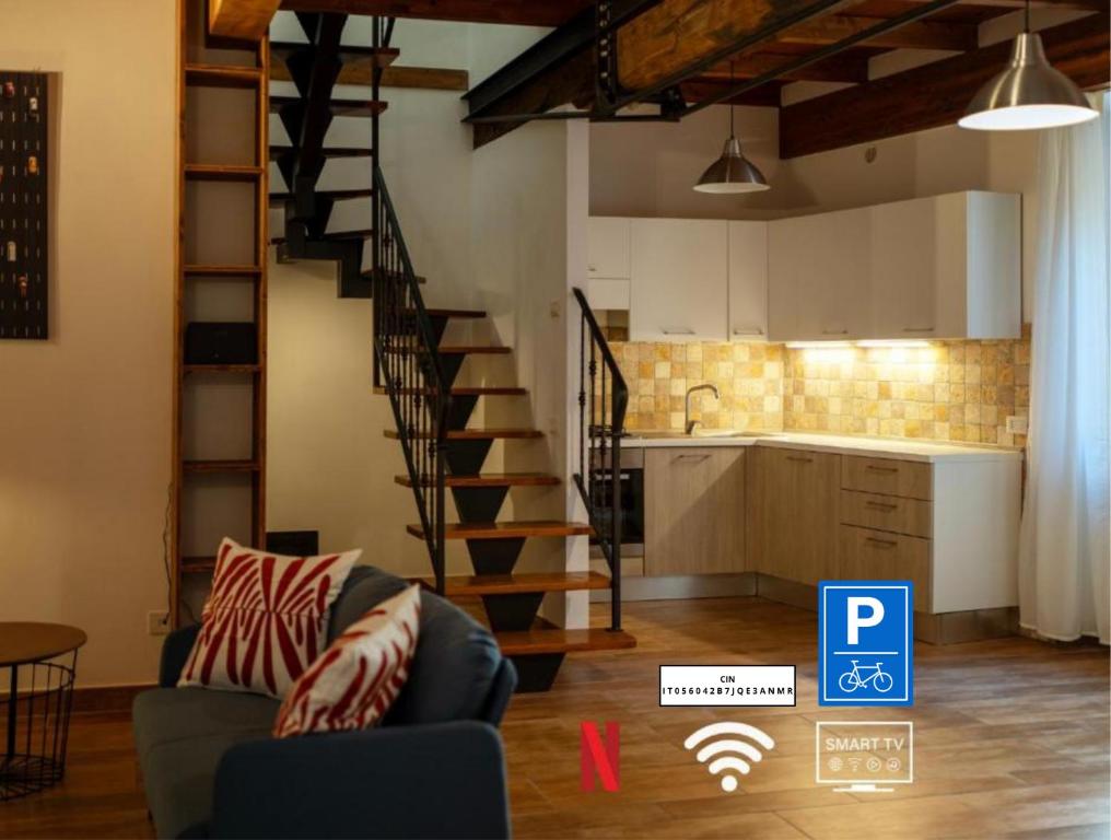 a kitchen and a living room with a spiral staircase at Sleeping in Orte Apartments in Orte