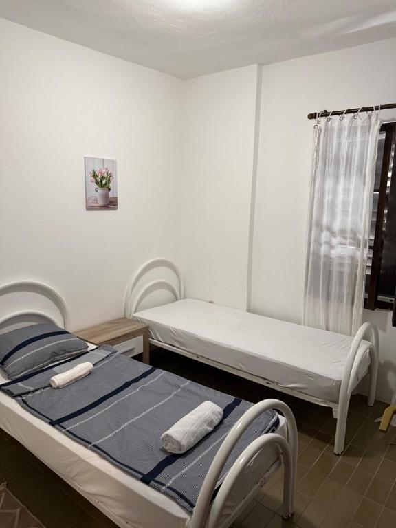 a hospital room with two beds and a window at Vista apartments in Risan