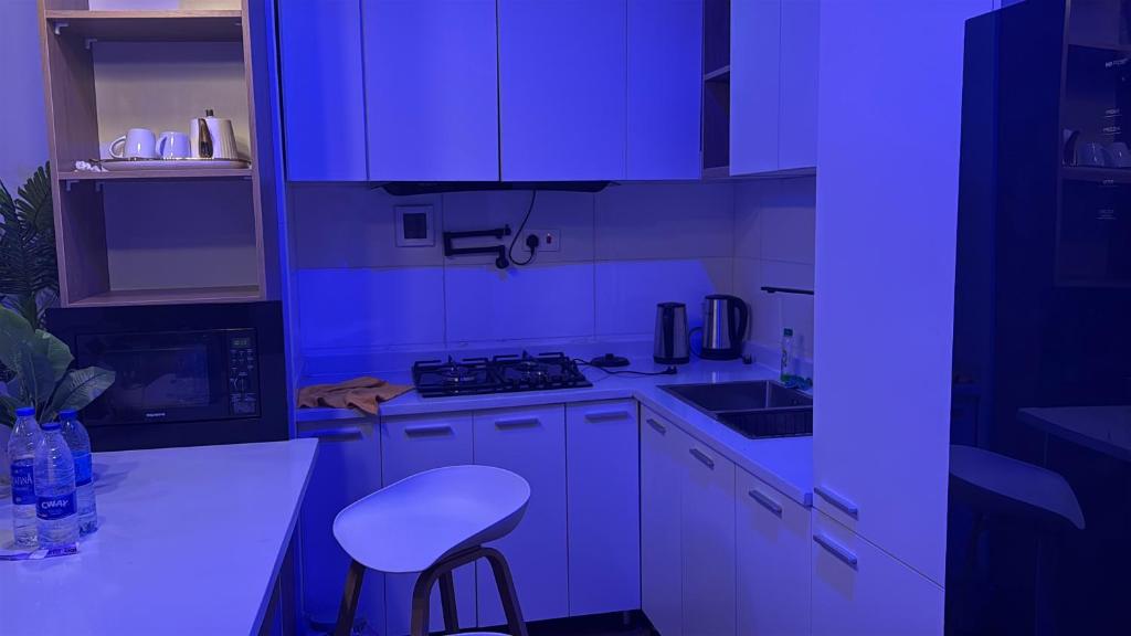 a kitchen with blue lighting in a kitchen at TM Homes in Abuja