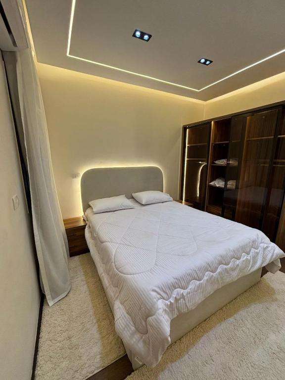 a bedroom with a large white bed in a room at Rent house b8 in Madinaty