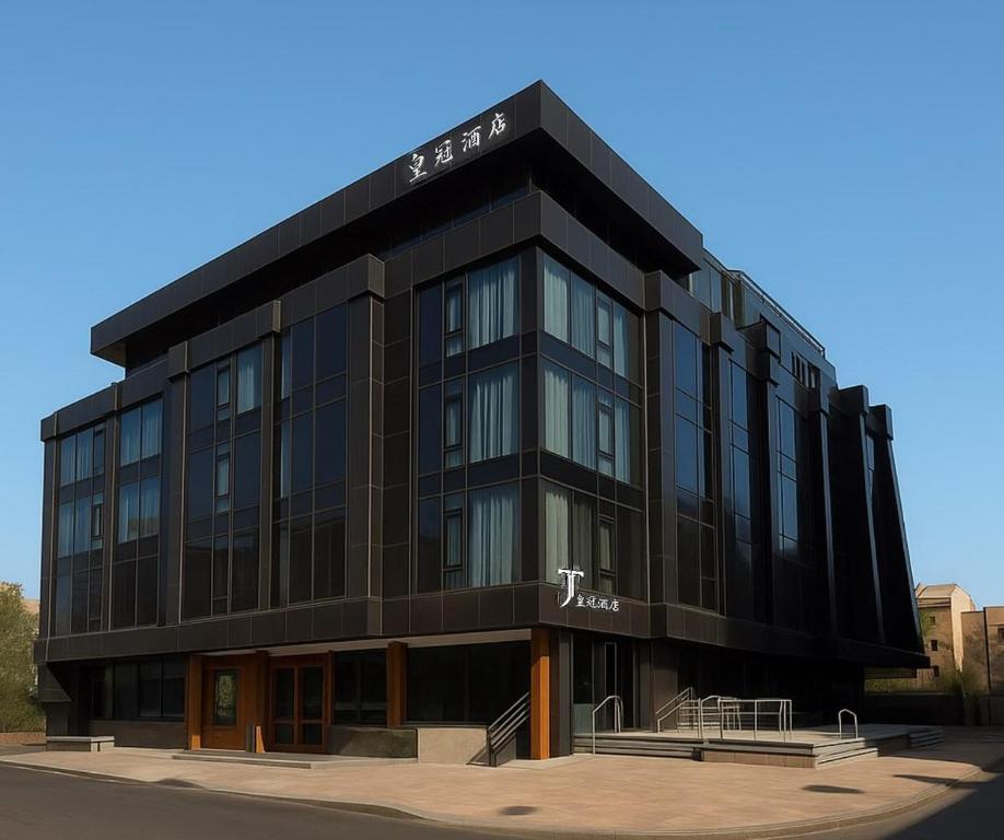 a black building with a sign on it at Taj Premium Hotel in Baghdād