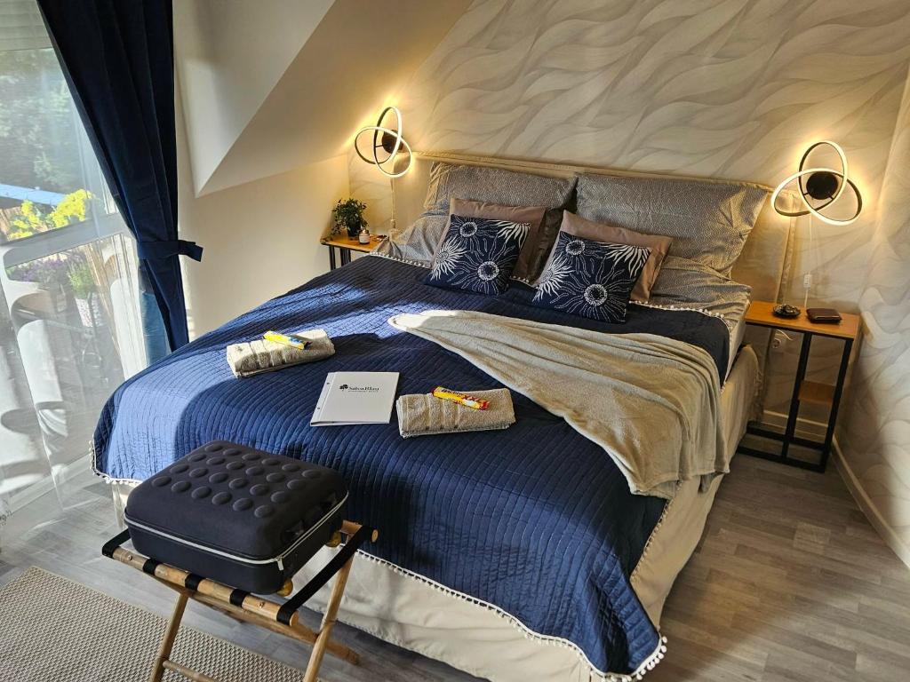 a bedroom with a large bed with a blue comforter at SilvaBlau Apartment Hévíz in Hévíz